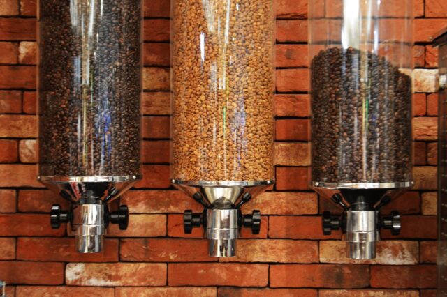 view of three varieties of coffee beans inside coffee dispensers